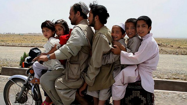 Afghan family on a Super Cub by Fardin Wahezi People riding a Super Cub to the picnics at the Khwaja Sahib Ansar in Hirat, Afghanistan